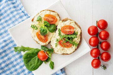 egg cheese ham dip, spread on open finger food sandwich with salad, tomato vegetables 