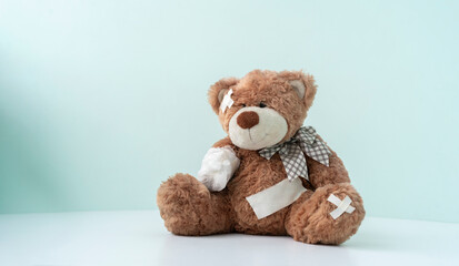 concept of pain and illness problem, teddy bear toy wrapped in bandage, accident injury
