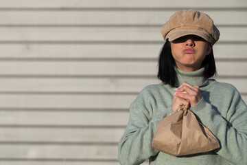 Woman hand holding paper bag. Funny photo. Fun. 