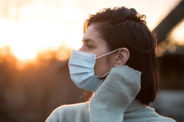 Beautiful Women In A Medical Mask. Close-up of a young woman with a surgical mask on her face...