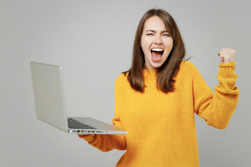 Young successful freelancer copywriter excited attractive caucasian woman in knitted yellow sweater...