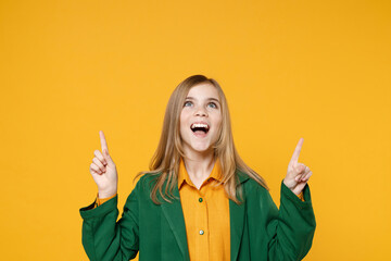 Little blonde kid girl 12-13 years old in casual clothes green shirt point index finger overhead on...