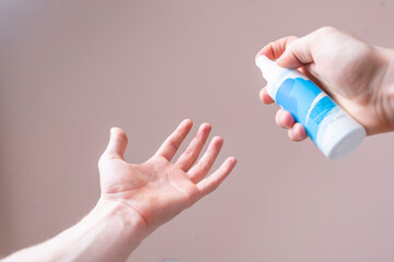 using a spray antibacterial bottle to wash hands, healthcare sanitizer protection
