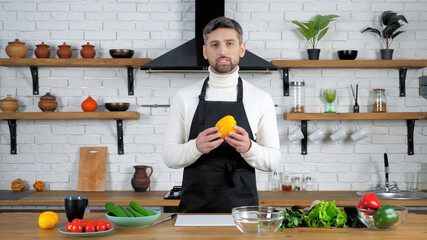 Man chef teacher in black apron records online remote video culinary webinar master class course...