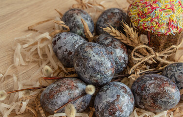 Beautiful Easter composition - colorful eggs, Easter cake, ears of wheat, traditionally elegant.