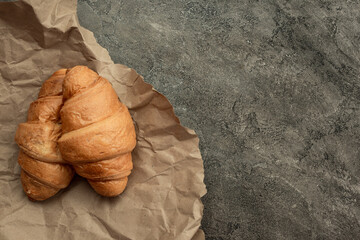 French croissant. Freshly baked croissants with jam on dark stone background. Tasty croissants with...