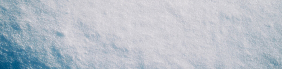 Snowdrifts in the field, the texture of snow. Background winter January, February. The sun is shining on a winter field. Cold Journey