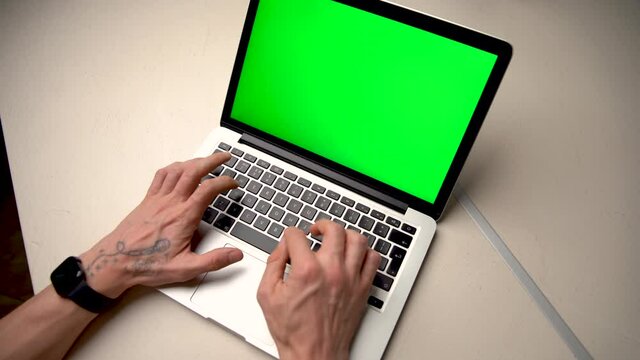 Man Using Chroma key screen laptop computer on desk at home stock video