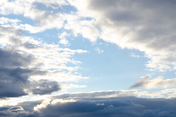 Fototapeta na wymiar Sky with dark clouds and a skylight in the center, soft focus
