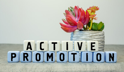 Soft cubes with the abbreviation ACTIVE PROMOTION with a flower