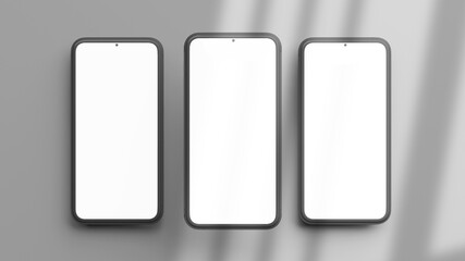 Three vertical phones mockup isolated on a grey background in flat lay and 3D rendering. Realistic template of cellphone frame and blank display concept for presentation