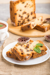 Homemade cake with raisins, dried persimmon and a cup of hot chocolate on a gray concrete background. side view, selective focus.