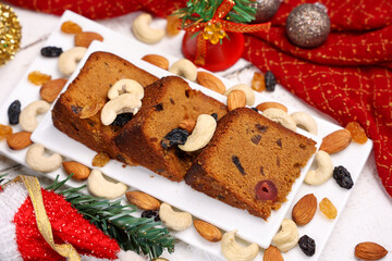 Indian Christmas celebration homemade Christmas plum cake cut into pieces for serving India Kerala...
