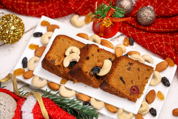 Indian Christmas celebration homemade Christmas plum cake cut into pieces for serving India Kerala Sri Lanka Fruitcake made of dried fruit, nuts, spices , rum for New Year party, Easter, Christmas Eve