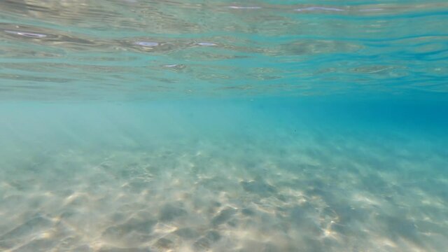 Underwater video of tropical exotic turquoise sandy sea bed as seen at summer