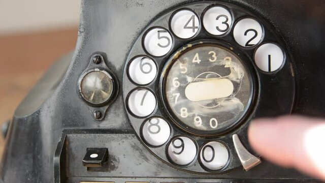 Dailing 411 on an old-fashioned rotary phone to get information