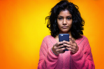 Beautiful Sri Lanka girl uses her phone looking in front of her