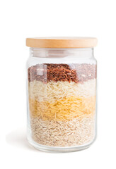 glass jar with different kinds of rice poured in layers isolated on white background. side view.