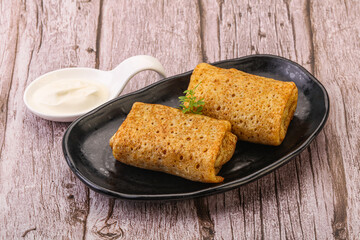 Staffed pancakes served sour cream