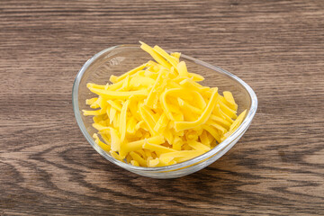 Shredded yellow cheese in the bowl