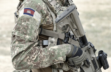 Soldier with assault rifle and flag of Cambodia on military uniform. Collage.