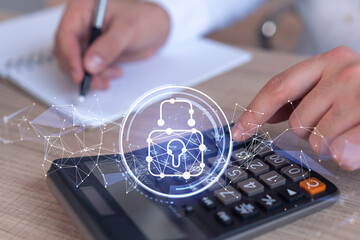 A businessman computing probability of risks in cyber security protection using calculator. Padlock...