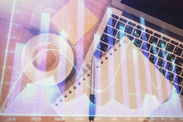 Double exposure of forex chart drawing over table background with computer. Concept of financial research and analysis. Top view.
