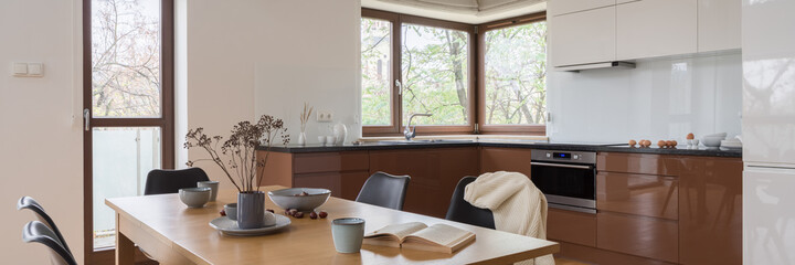 Wooden dining table in kitchen, panorama