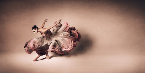 Fototapeta premium Graceful woman dancing in flowing dress