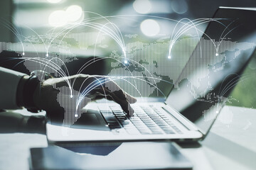 Double exposure of abstract digital world map with connections and hands typing on laptop on background, research and strategy concept