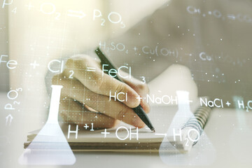 Creative chemistry hologram with man hand writing in notepad on background, pharmaceutical research...