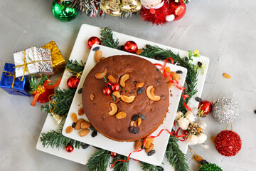 Indian Christmas celebration serving homemade Christmas plum cake India Kerala. Fruitcake made of dried fruit, nuts, spices , rum for New Year party, Easter, Christmas Eve