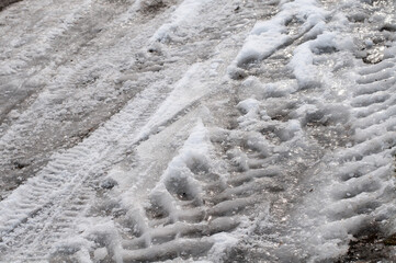 frozen tire tracks on a street in winter