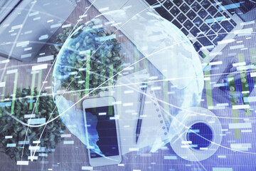 Double exposure of business theme hologram over desktop with phone. Top view. Mobile international trade connection concept.
