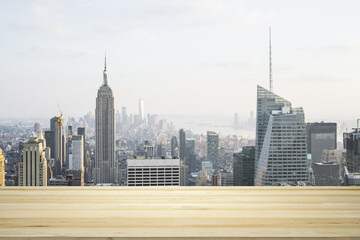 Empty tabletop made of wooden dies with New York city view at daytime on background, template