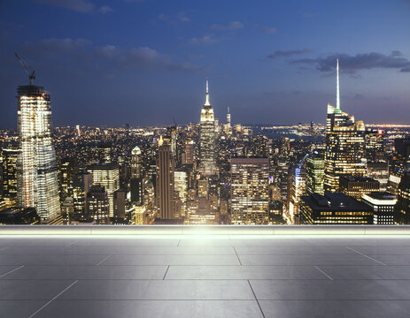 Empty concrete rooftop on the background of a beautiful Manhattan skyline at evening, mockup