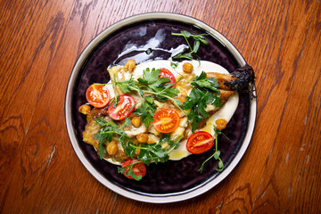 top view salad with cherry tomatoes, banana, chickpeas and herbs