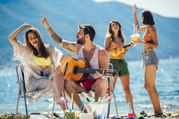Young friends having fun at the beach on a sunny day.