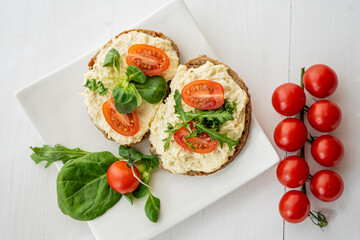 egg cheese ham dip, spread on open finger food sandwich with salad, tomato vegetables  - 418894889