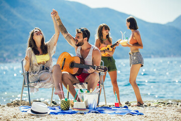 Young friends having fun at the beach on a sunny day.