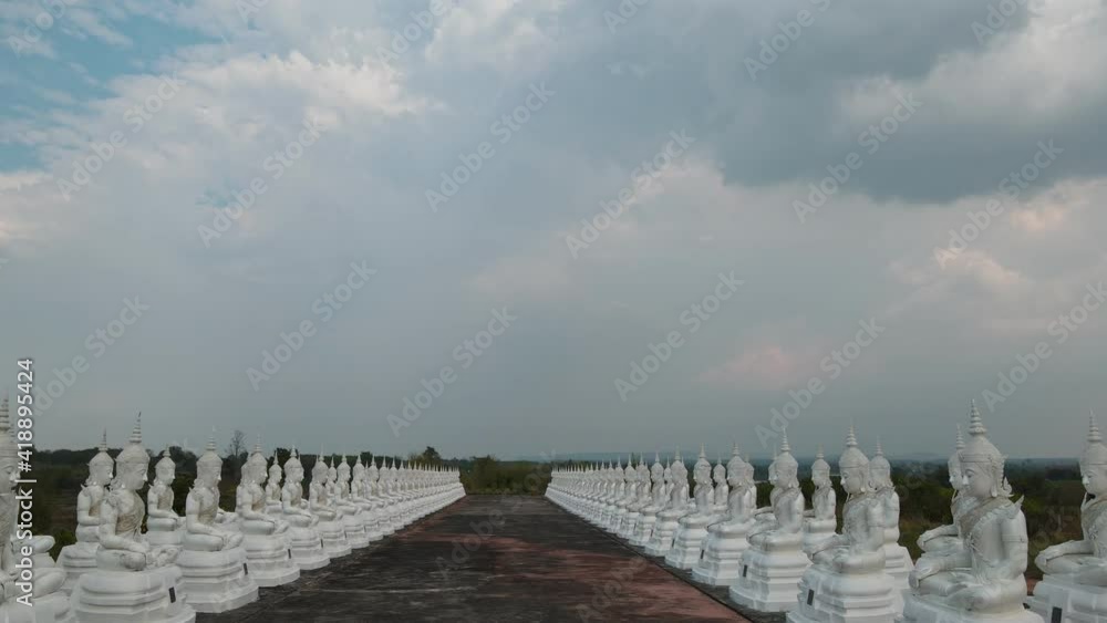 Wall mural row white buddha statue with blue sky