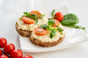 egg cheese ham dip, spread on open finger food sandwich with salad, tomato vegetables  - 418895441