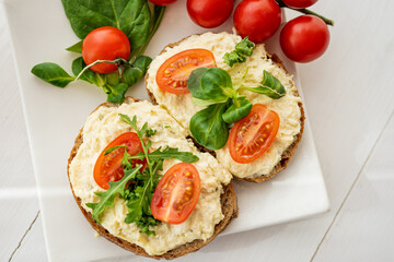 egg cheese ham dip, spread on open finger food sandwich with salad, tomato vegetables 