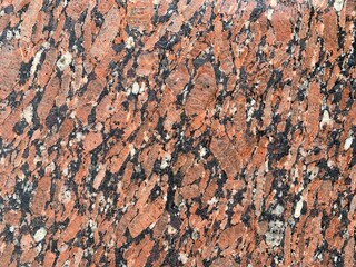 Natural stone red granite texture background. Bright hard red granite texture. Red granite texture stone background. Red granite texture untreated surface. Facing material horizontal background.
