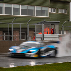 A shot of a racing car as it circuits a track.