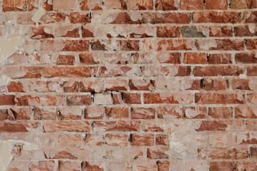old red brick wall with cracked and damaged stones, background fro a template, no person