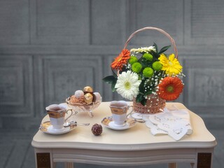 Still life with tea and basket of flowers