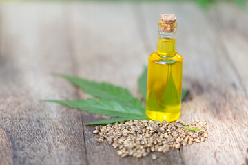 Hemp oil products in small bottles placed together.Hemp oil, CBD extracted from fresh hemp extract.Green marijuana background. There is space for entering text.