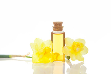 Essence of flowers  on white in beautiful glass jar