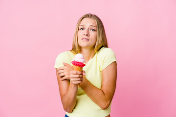 Young russian woman eating an ice cream isolated going cold due to low temperature or a sickness.